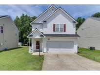 Charming two-story home with white siding, attached garage, and well-maintained lawn at 1310 Southgate Dr, Raleigh, NC 27610
