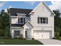 Charming two-story home boasts a painted brick exterior, attached two-car garage, and attractive landscaping at 1613 Malcus Ct # 68, Fuquay Varina, NC 27526