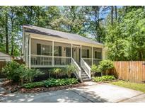 Charming home with a lovely screened front porch and inviting curb appeal at 2007 Eastwood Dr, Durham, NC 27703