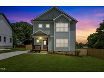 Charming two-story home with a well-manicured lawn, showcasing its inviting facade at twilight at 2521 Newbold St, Raleigh, NC 27603