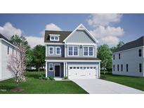 Charming two-story home with a two-car garage, manicured lawn, and classic architectural details at 259 Meadowbark Bnd # 32, Garner, NC 27529