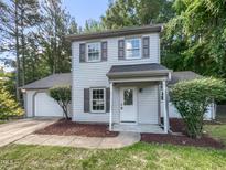 Charming two-story home with light siding, landscaped yard, and an attached garage, great curb appeal at 2705 Ramblegate Ln, Durham, NC 27705