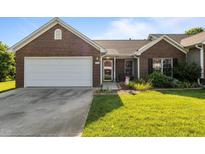 Charming brick home with a two-car garage, landscaped lawn, and inviting front porch at 3027 Maple Ave # U1, Burlington, NC 27215