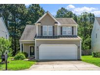 Charming two-story home with a two-car garage and well-maintained landscaping at 4009 Patriot Ridge Ct, Raleigh, NC 27610
