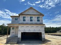 New two-story home with visible framework and covered front porch, ready to customize at 433 Old Fashioned Way Way, Lillington, NC 27546