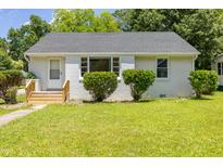 Charming single-story home with a well-maintained lawn and manicured bushes at 605 E Montgomery St, Henderson, NC 27536