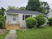 Charming one-story home with a freshly painted exterior, new stairs, and a well-maintained lawn at 605 E Montgomery St, Henderson, NC 27536