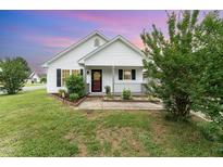 Charming single-story home featuring a cozy front porch, neat landscaping, and inviting curb appeal at 606 Arden St, Burlington, NC 27215