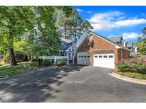 Inviting home with a two-car garage, well-kept lawn, and meticulously landscaped garden at 7601 Wellesley N Park, Raleigh, NC 27615