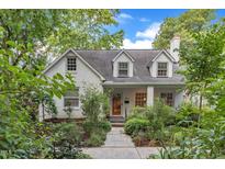 Charming white brick home with dormers and a beautifully landscaped front yard at 821 Onslow St, Durham, NC 27705