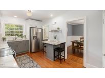 Bright kitchen with stainless steel appliances, a marble countertop, and eat-in breakfast bar at 821 Onslow St, Durham, NC 27705