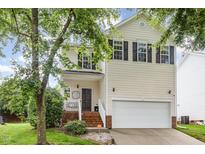 Charming two-story home with a well-maintained lawn and an attached two-car garage at 109 Troyer Pl, Apex, NC 27502