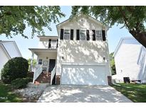 Charming two-story home with a two-car garage, well-maintained lawn and beautiful tree at 109 Troyer Pl, Apex, NC 27502