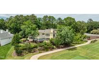 Stunning home with lush landscaping, golf course views, and a backyard patio at 112 Lancaster Dr, Chapel Hill, NC 27517