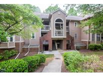 Charming condo exterior with brick accents and well-maintained landscaping at 115 Abingdon Ct # 2B, Cary, NC 27513