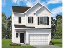 Charming two-story home featuring a classic white exterior and a spacious two-car garage at 144 Bruce Dr, Dunn, NC 28334
