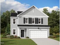 Charming two-story home featuring a two-car garage, black shutters, and a well-maintained lawn at 153 Gladstone Loop, Clayton, NC 27520