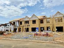 New construction townhomes displaying framing, and plywood sheathing with visible underlayment along the roofs at 153 Ripple Way # 208, Clayton, NC 27520