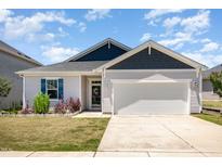 Charming single-story home with a two-car garage, and well-manicured lawn at 157 Willow Grove Ln, Fuquay Varina, NC 27526