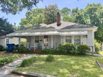 Charming single-story home featuring a covered front porch and well-maintained lawn at 1704 Southgate St, Durham, NC 27703