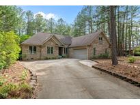 Beautiful brick home with a well-maintained lawn and long driveway at 174 Woodwedge Way, Sanford, NC 27332