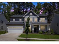 Beautiful two-story home featuring a well-manicured lawn and an attached two-car garage at 2009 Latham Oaks Ave, Wake Forest, NC 27587