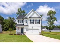 Charming two-story home featuring a white exterior, black shutters and a well-manicured front lawn at 224 Wild Turkey Way, Lillington, NC 27546