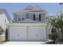 Charming two-story home featuring a two-car garage and well-maintained landscaping at 3021 Remington Oaks Cir, Cary, NC 27519
