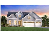 Charming two-story home with three-car garage, grey siding, and multiple gables at 305 Mugby Rd # 162, Raleigh, NC 27610