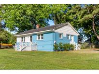 Charming single-story home with blue painted brick and lush green lawn at 403 N Webb St, Selma, NC 27576