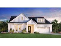 Charming new construction featuring board and batten siding, dormer windows, and a two-car garage at 405 Mugby Rd # 153, Raleigh, NC 27610