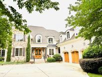 Stunning stone and brick home with a three-car garage and beautifully landscaped front yard at 5205 Newstead Manor Ln, Raleigh, NC 27606