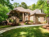 Stately brick home boasts mature landscaping, manicured lawn, and inviting front entrance at 540 Vista Del Lago Ln, Wake Forest, NC 27587