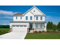 Charming two-story home with a covered front porch, manicured lawn, and attached two-car garage at 62 Lismore St, Sanford, NC 27330