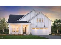 Charming new construction home featuring vertical siding, two-car garage, professional landscaping, and inviting front porch at 628 Gainer Dr # 18, Raleigh, NC 27610