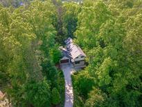 Stunning aerial view of home nestled among lush green trees with a private driveway at 9021 Albatross Ct, Raleigh, NC 27613