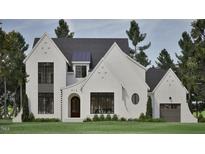 Stunning exterior of home with brick, a dark gray roof, and black frame windows creating a very modern look at 913 Tyrrell Rd, Raleigh, NC 27609