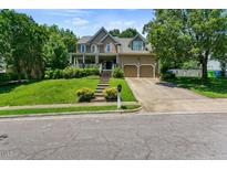 Inviting two-story home with a well-manicured lawn and a two-car attached garage at 10205 Sorrills Creek Ln, Raleigh, NC 27614