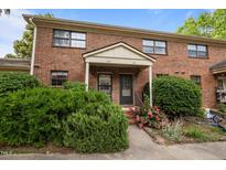 Traditional brick townhouse with landscaped yard and covered entryway with nice shrubbery and flowers at 105 Fidelity St # B19, Carrboro, NC 27510