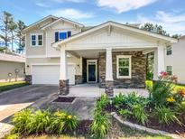 Charming home with stone accents, covered front porch, and beautifully landscaped front yard at 148 Daneborg Rd, Durham, NC 27703
