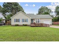 Charming single-story home featuring a ramp to the front door, complemented by lush green lawn and mature trees at 1609 Forest Rd, Wake Forest, NC 27587