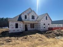 A partially constructed two-story home with visible framework and a blue sky backdrop at 163 Batten Hill Ln, Selma, NC 27576