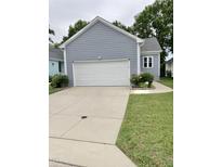 Garage of a blue home with an ample driveway and landscaping at 1944 Castle Pines Dr, Raleigh, NC 27604