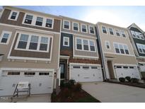 New townhomes with attached garages and neutral exteriors offer modern curb appeal at 2733 Hunter Woods Dr # 570, Apex, NC 27502