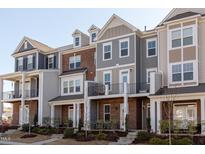 Charming townhomes with varied architectural styles and well-maintained landscaping at 2929 Great Lawn Rd, Apex, NC 27502