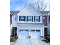 Inviting townhome with a two-car garage, neutral siding, and dark shutters at 4355 Pond Pine Trl, Morrisville, NC 27560