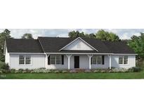 Charming single-story home with a welcoming front porch and beautifully landscaped front yard at 4450 Poppy Mallow Ln, Oxford, NC 27565