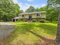 Traditional two-story home with an attached two-car garage and a well-maintained lawn with mature trees at 4508 Old Us 421 N N, Siler City, NC 27344