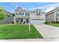Charming two-story home with a well-manicured lawn, inviting front porch, and a two-car attached garage at 4907 Sleepy Falls Run, Knightdale, NC 27545