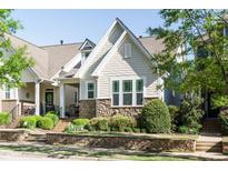 Charming home with stone accents, well-maintained landscaping, and a welcoming front porch at 5638 Wade Park Blvd, Raleigh, NC 27607